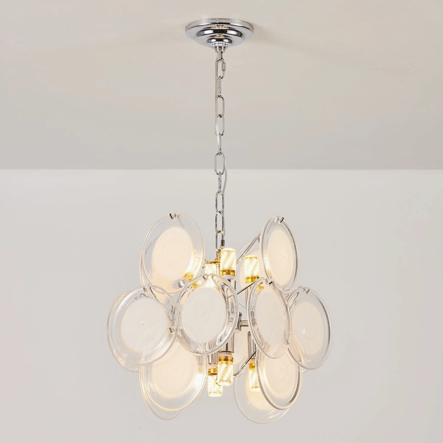 Brunelle pendant light fixture with multiple glass disc shades creating layered luminosity and visual rhythm