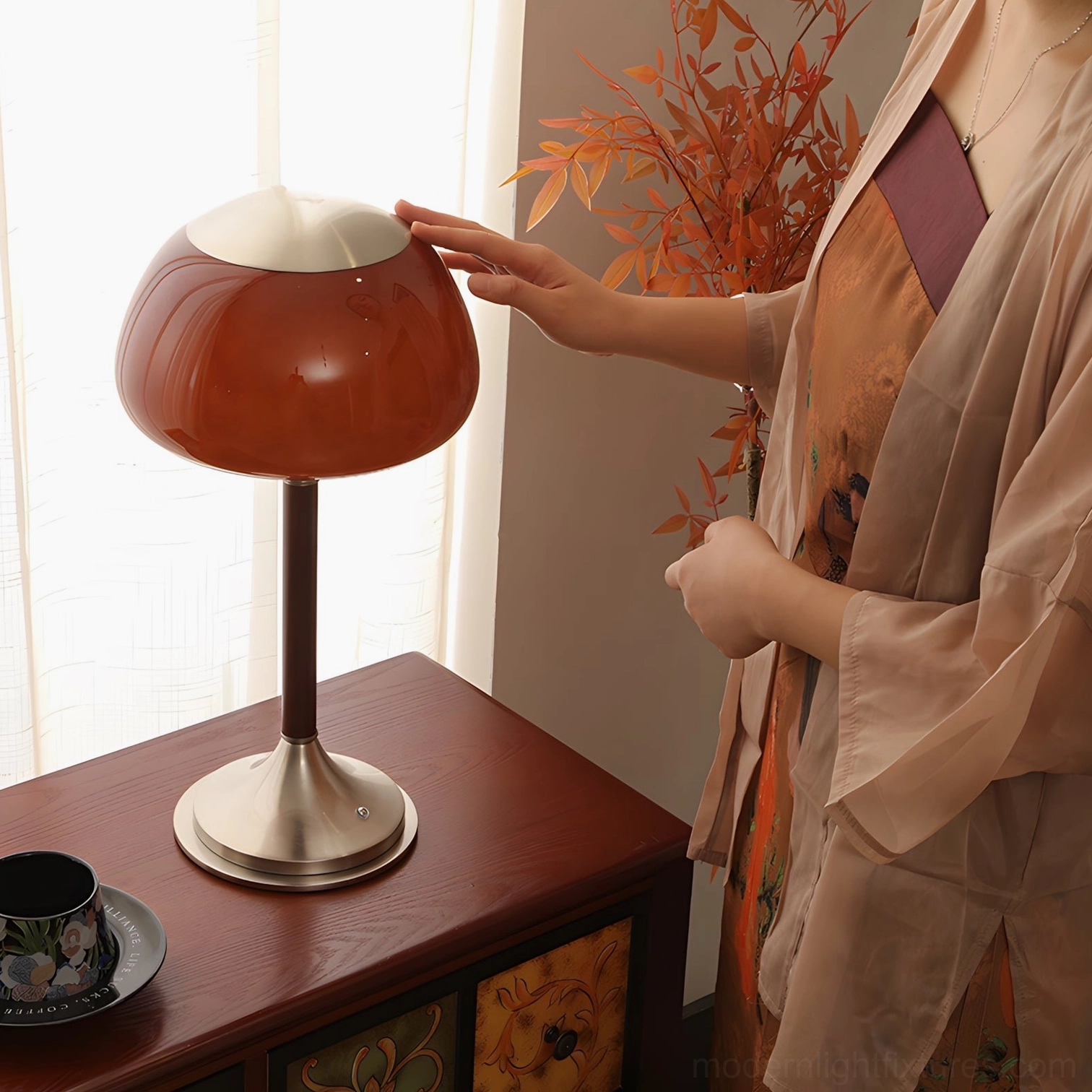 Brunello table lamp three-quarter angle view on wooden surface with autumn foliage styling