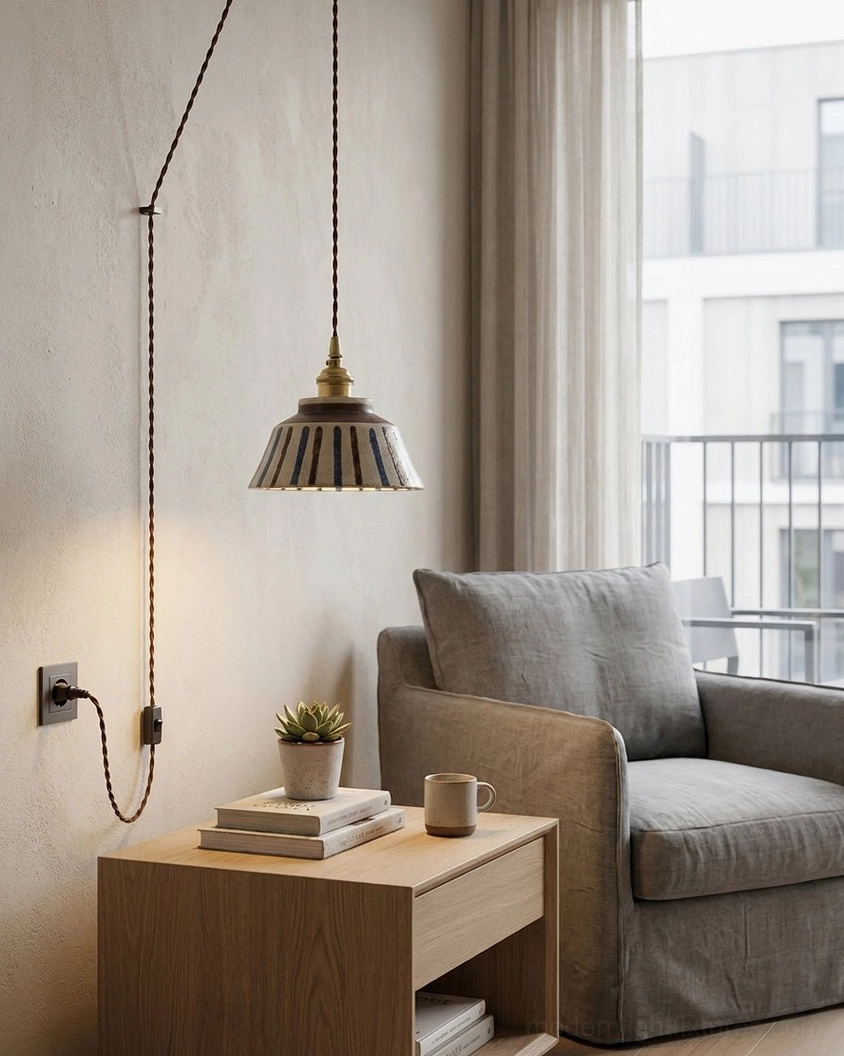 Hand-painted ceramic pendant fixture with brushstroke pattern in cozy living room lounge setting with neutral decor