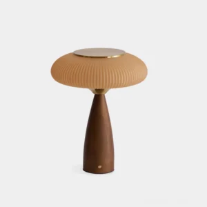 Brynn rechargeable cordless table lamp with ribbed amber glass shade and walnut wood base with gold metal accents, front studio view