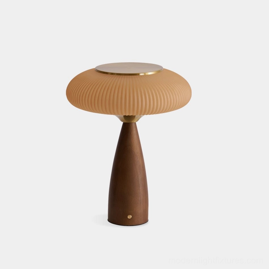 Brynn rechargeable cordless table lamp with ribbed amber glass shade and walnut wood base with gold metal accents, front studio view
