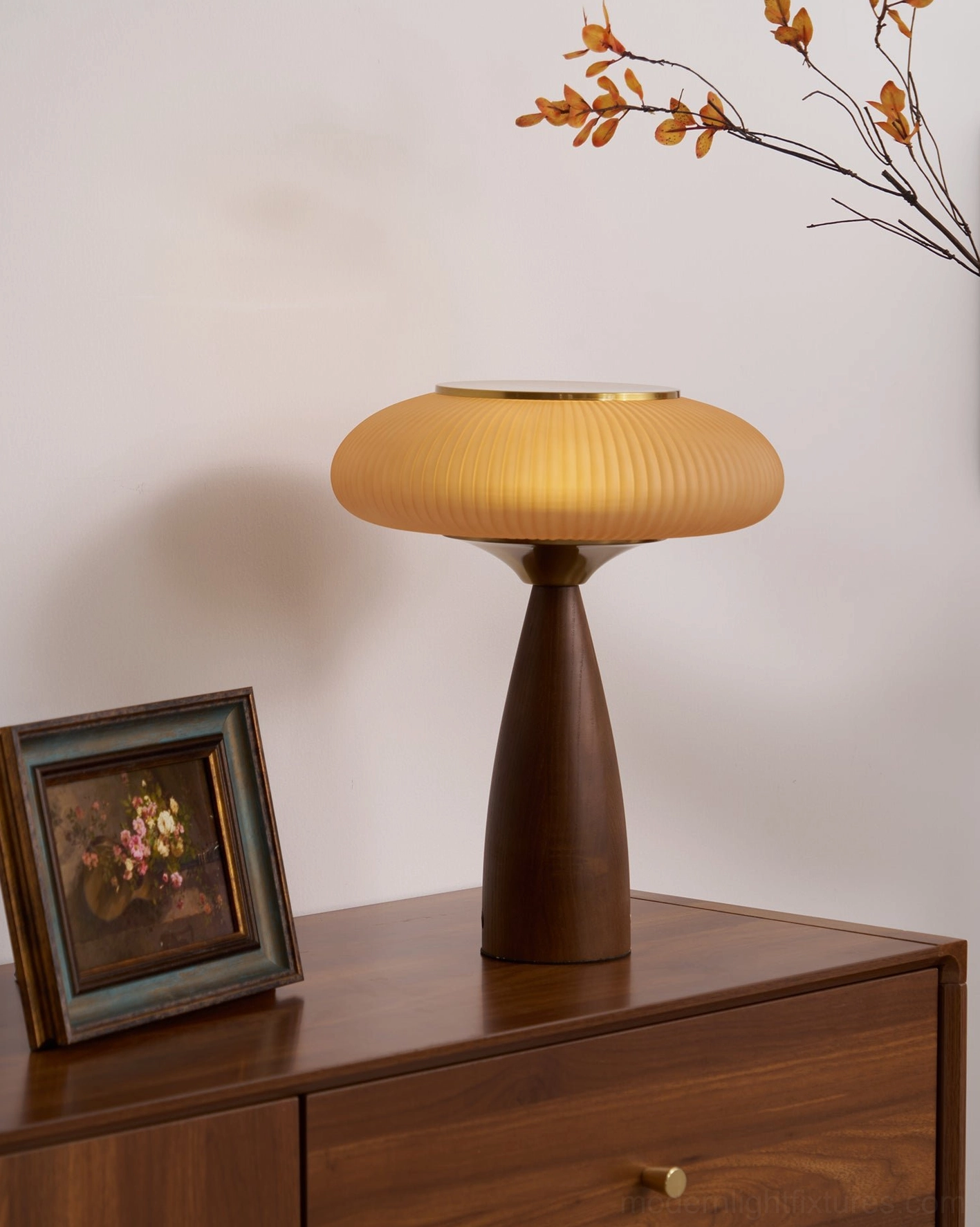 Brynn table lamp on walnut nightstand with framed artwork and dried branch decor, mid-century modern bedroom styling