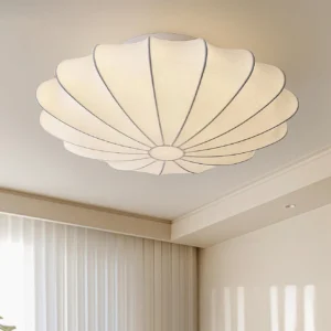 Bubble ceiling light fixture installed in contemporary farmhouse kitchen with cream fabric shade and dark metal trim