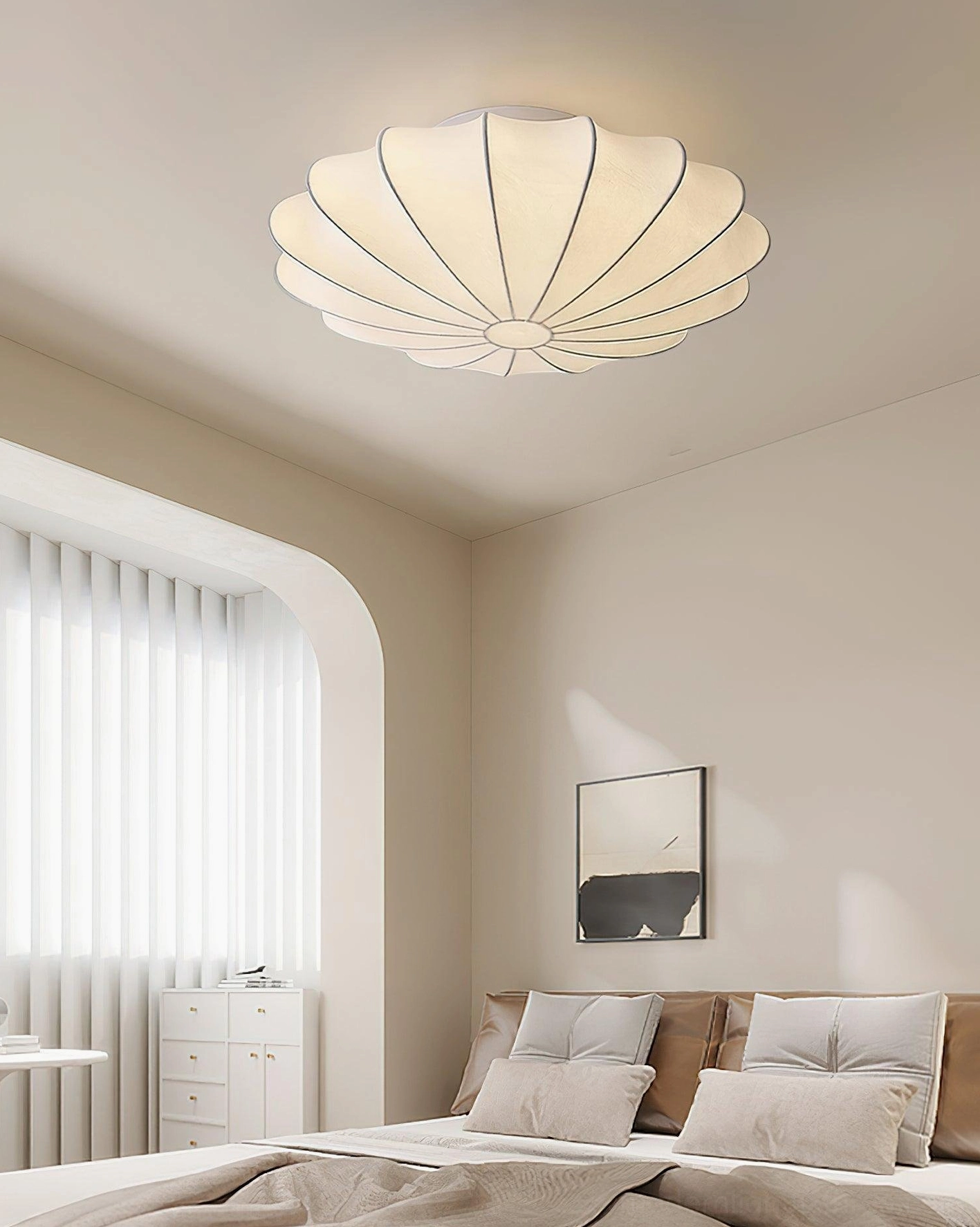 Modern bubble pendant light in minimalist bedroom creating warm ambient lighting with soft sculptural form