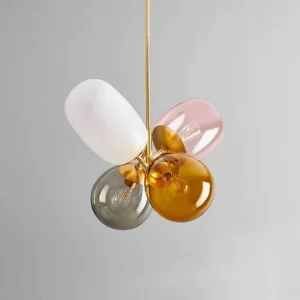 Four-head bubble pendant lamp with mixed color glass shades and gold hardware - side angle view