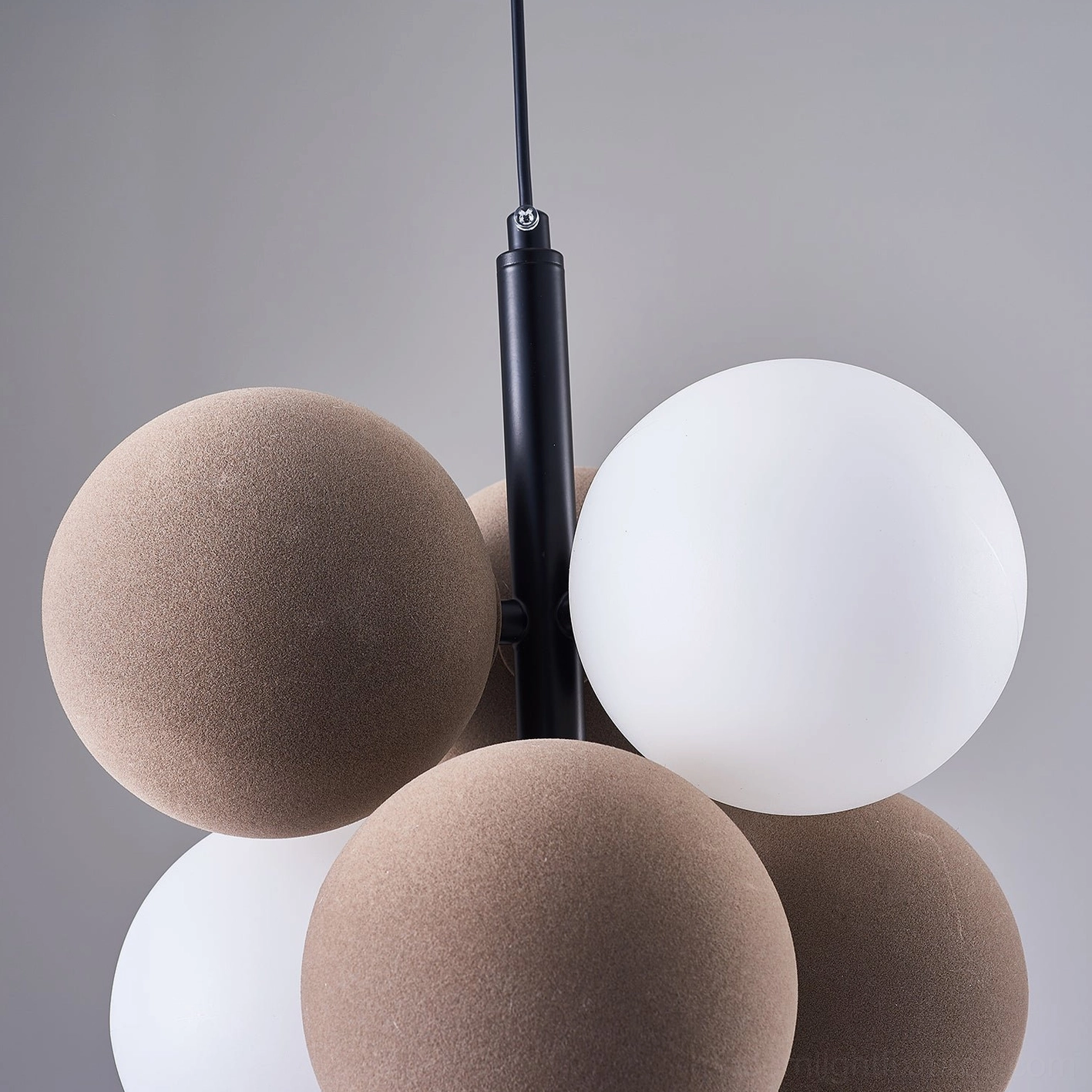 Bubble cluster pendant light over gallery wall creating artistic focal point