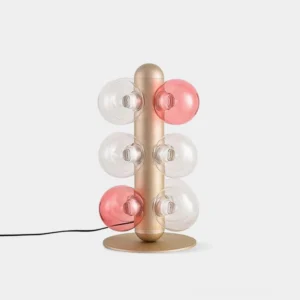 Hand-blown glass bubble table lamp with champagne gold base, front studio view showing clear and rose-tinted glass orbs