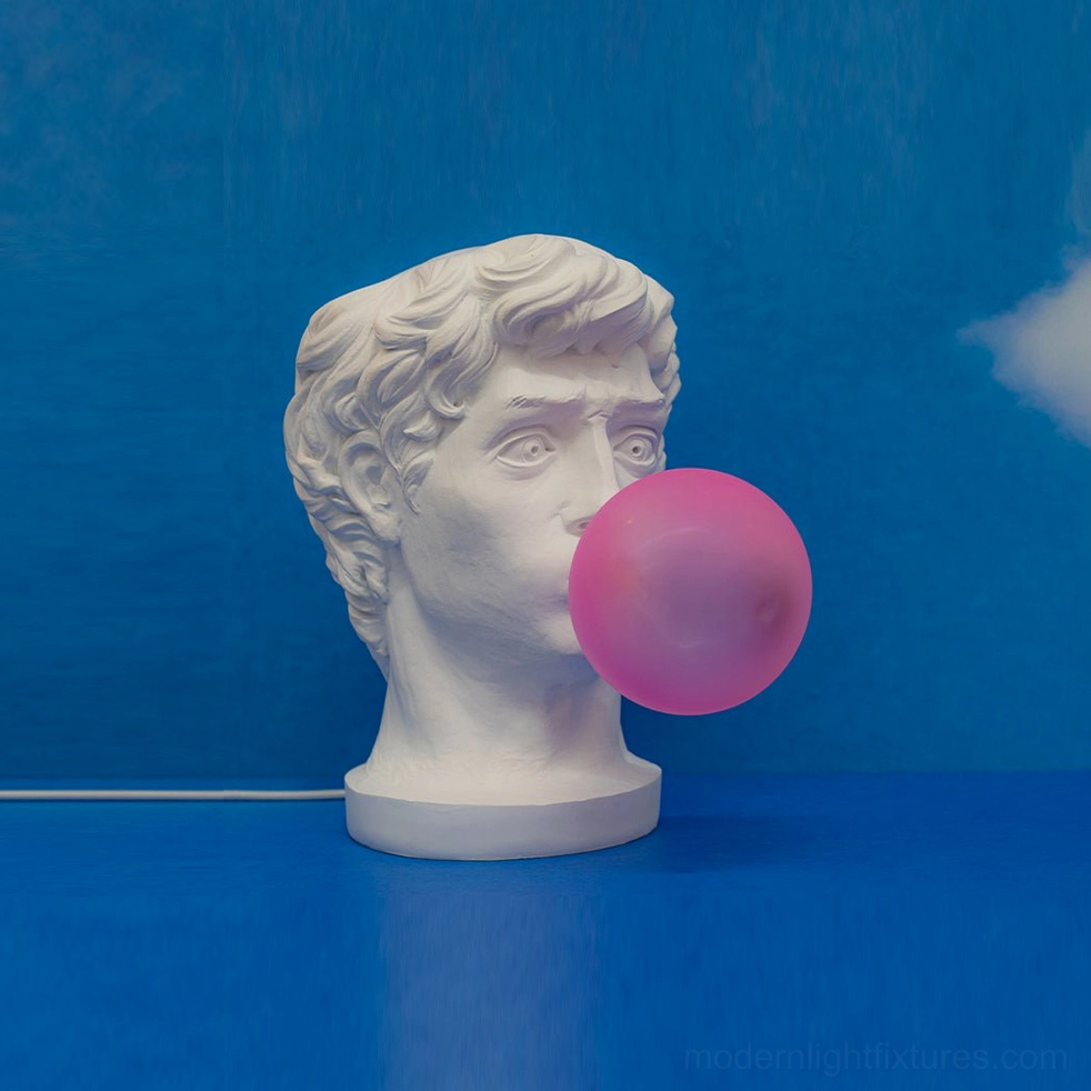 Bubblegum Boy table lamp back view showing resin sculptural form and pink glass globe illumination