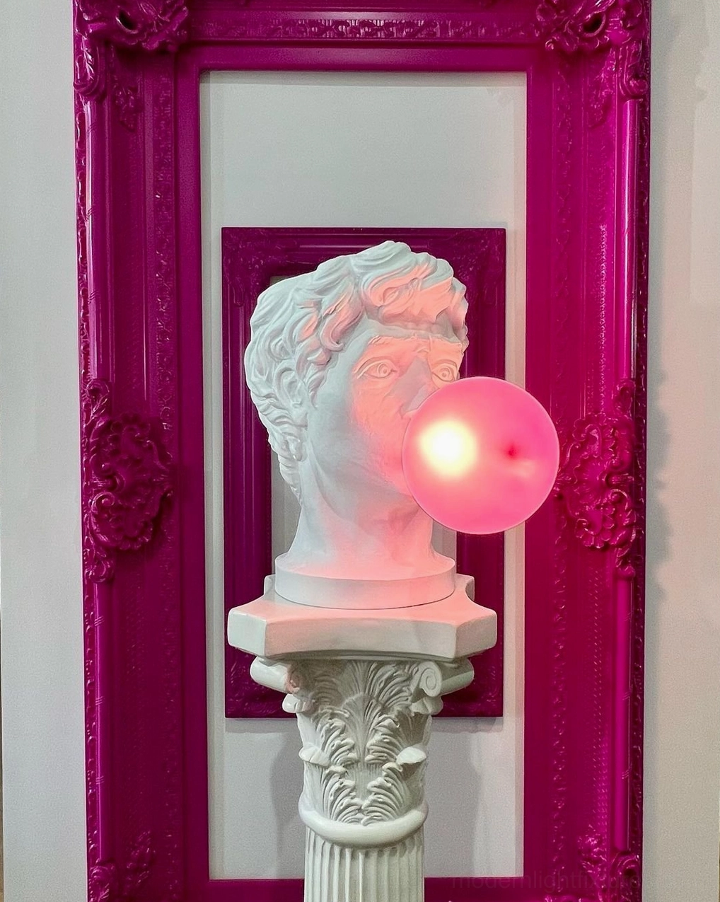 Bubblegum Boy resin table lamp in creative studio or home office workspace with art and design elements