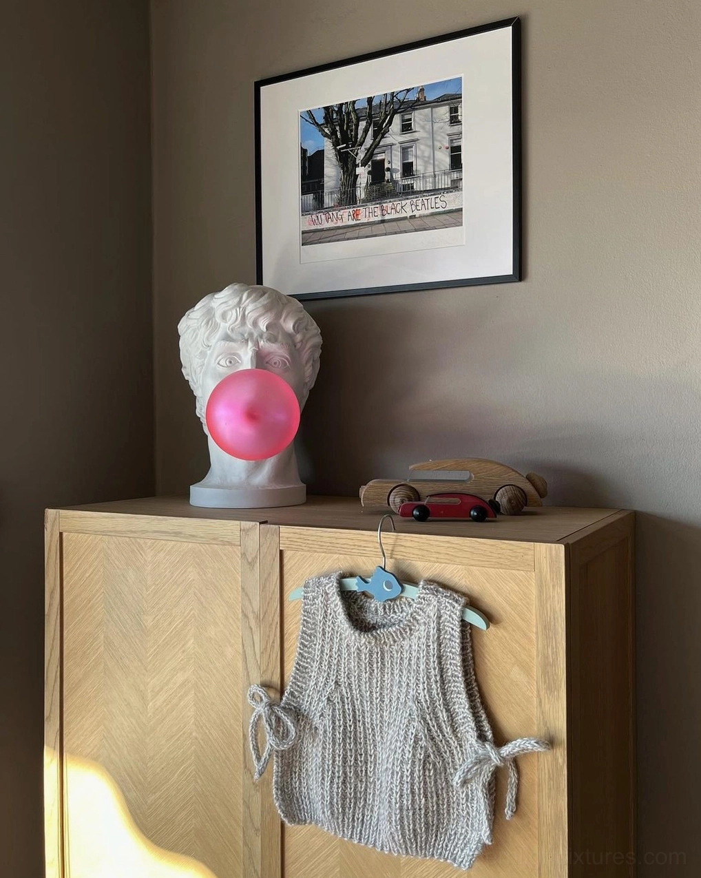 Bubblegum Boy sculptural table lamp as focal point on gallery shelf with complementary decor items