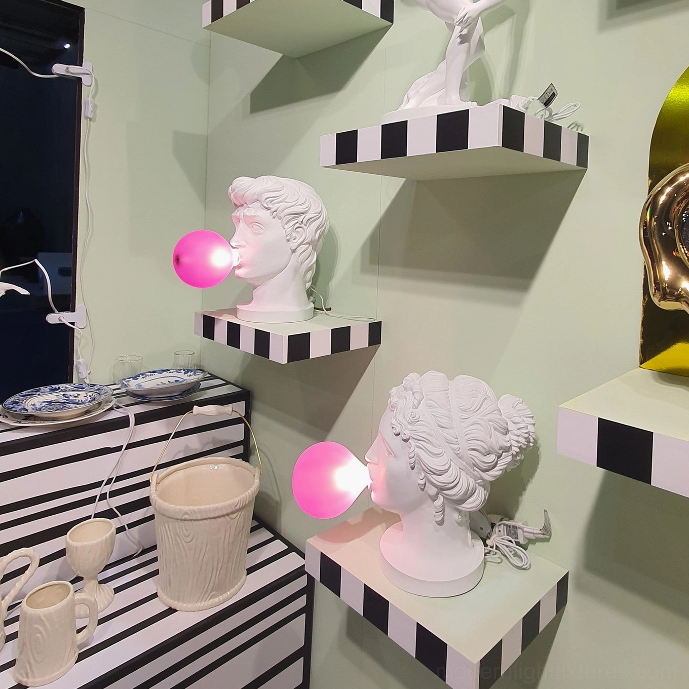 Bubblegum Boy table lamp on nightstand creating soft pink glow in bedroom evening setting