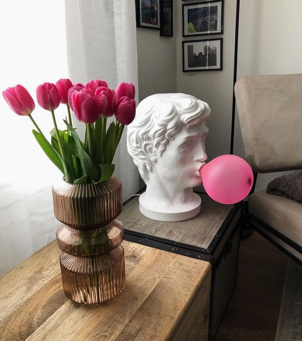 Bubblegum Boy resin lamp sculptural form with expressive features in various lighting conditions