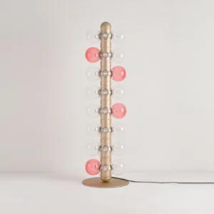 Bubbles floor lamp partial view illuminated pink glass balls modern LED fixture with metal base and power cord