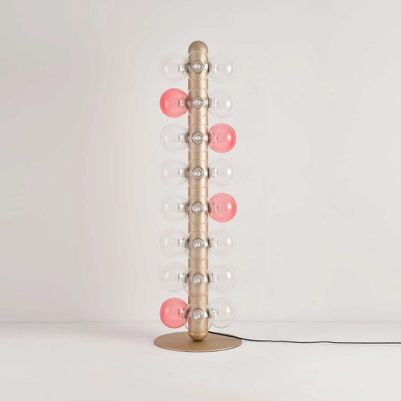 Bubbles floor lamp partial view illuminated pink glass balls modern LED fixture with metal base and power cord