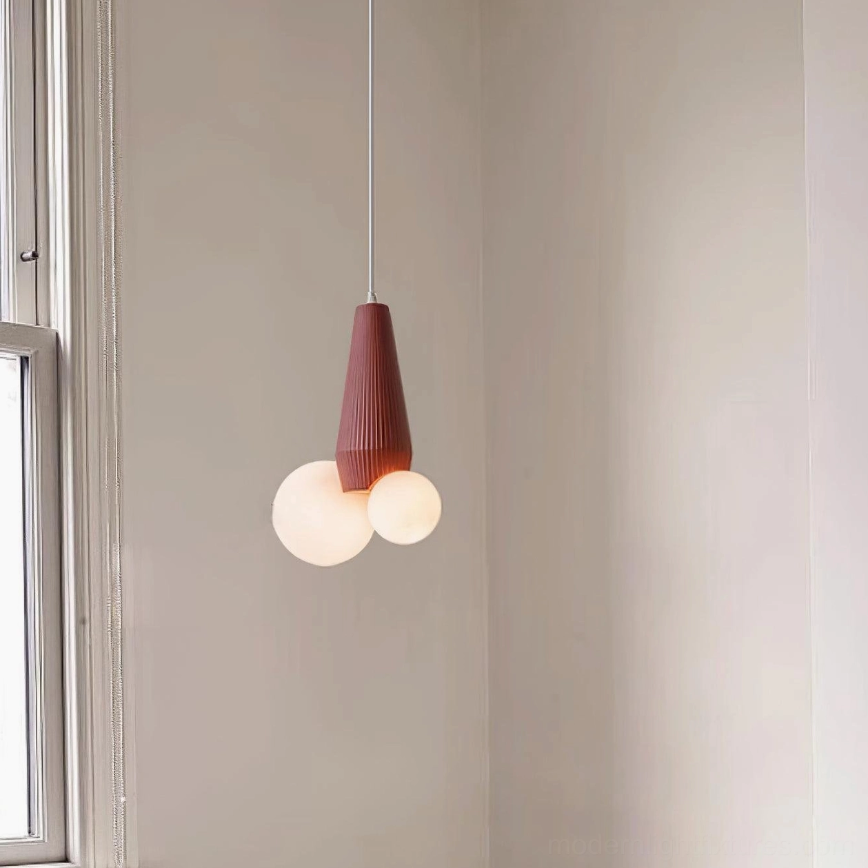 Contemporary burgundy red pendant light with dual frosted white glass shades in minimalist bedroom