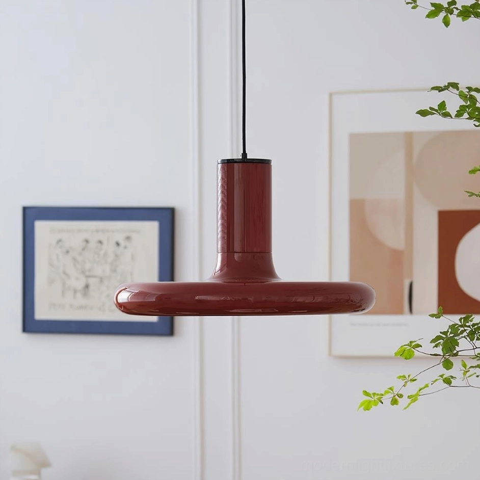 Red disc pendant light with wine red glossy finish three-quarter side view residential interior