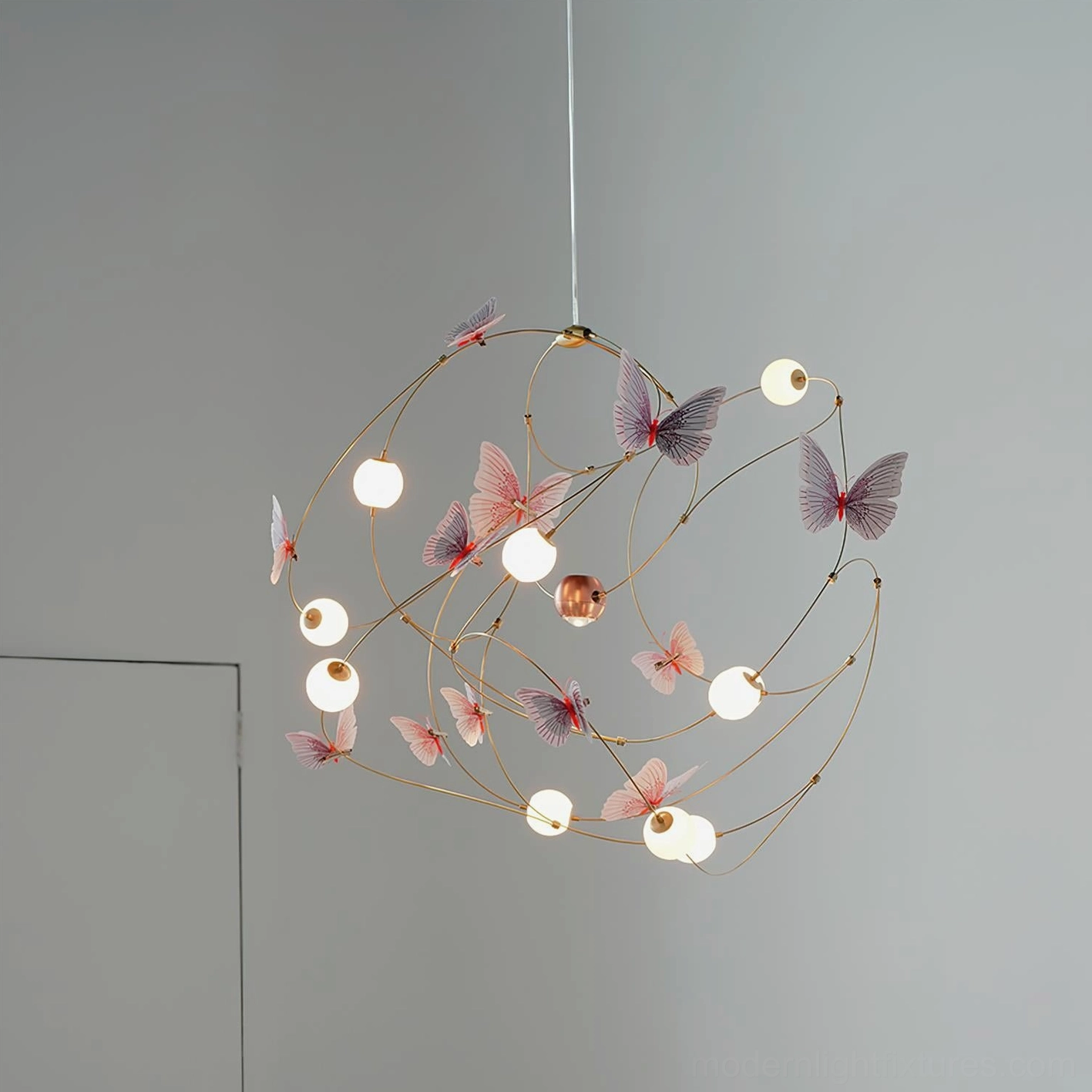 Contemporary butterfly pendant chandelier with acrylic sphere shades and sculptural brass wire design for artistic interiors