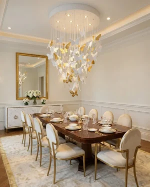 Modern butterfly chandelier suspended above elegant dining table in formal luxury dining room with wooden furniture and gold-framed chairs