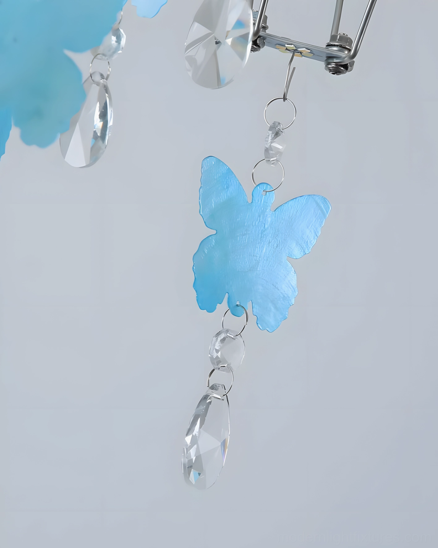 Butterfly dream chandelier suspended in elegant entryway or foyer space showing grand statement scale and eye-level perspective of crystal refraction and light distribution