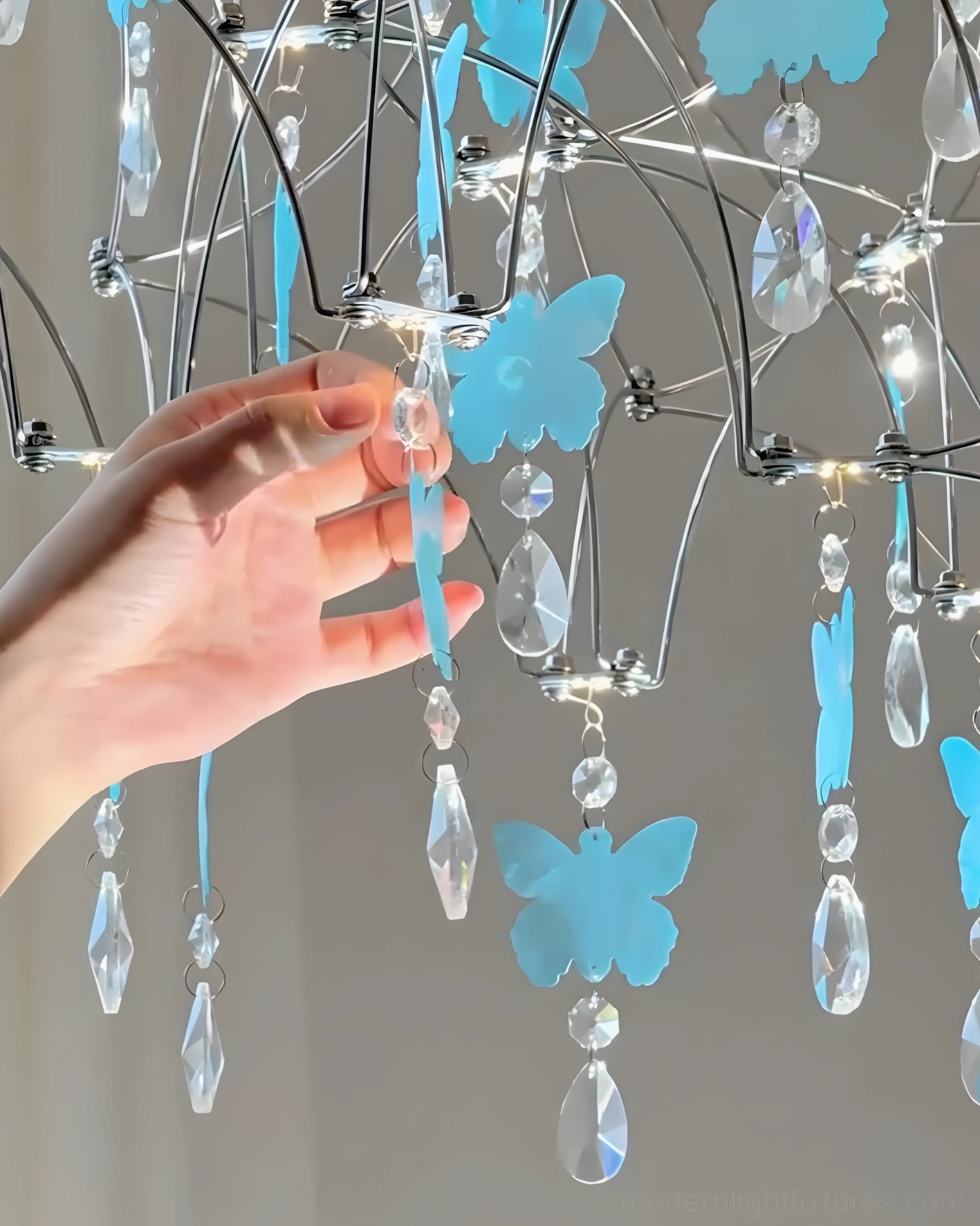 Butterfly dream crystal chandelier illuminating sophisticated living space with classic furnishings demonstrating versatility across transitional and romantic interior styles