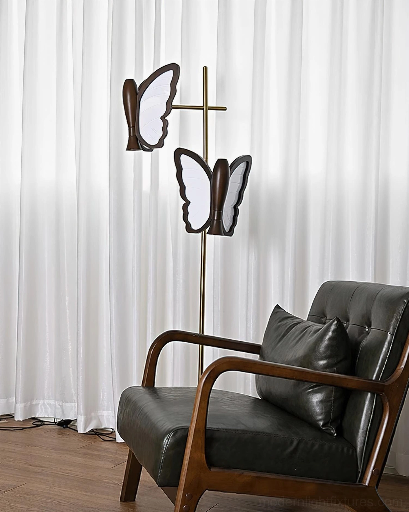 Butterfly floor lamp illuminated showing warm ambient lighting, dual butterfly-shaped lamps creating artistic shadows