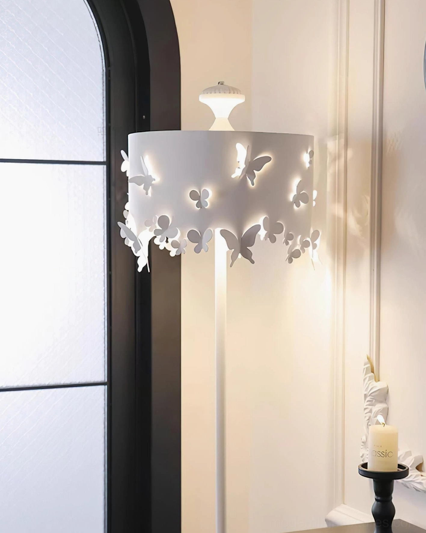 Modern butterfly floor lamp demonstrating light diffusion through cut-out shade pattern in contemporary interior space