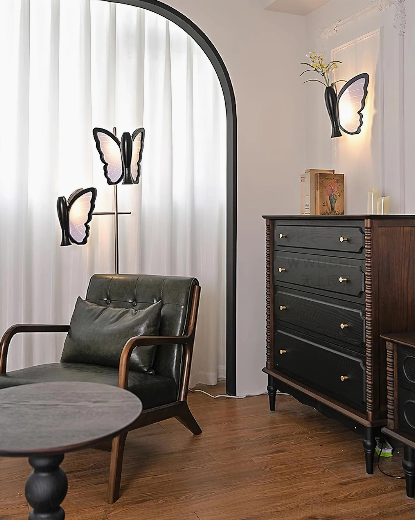 Butterfly floor lamp paired with matching wall lamp in vintage living room, dark wooden furniture, leather armchair