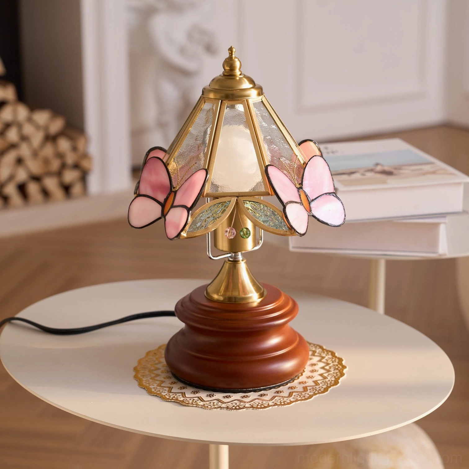 Tiffany-style butterfly table lamp illuminated showing warm light through pink stained glass