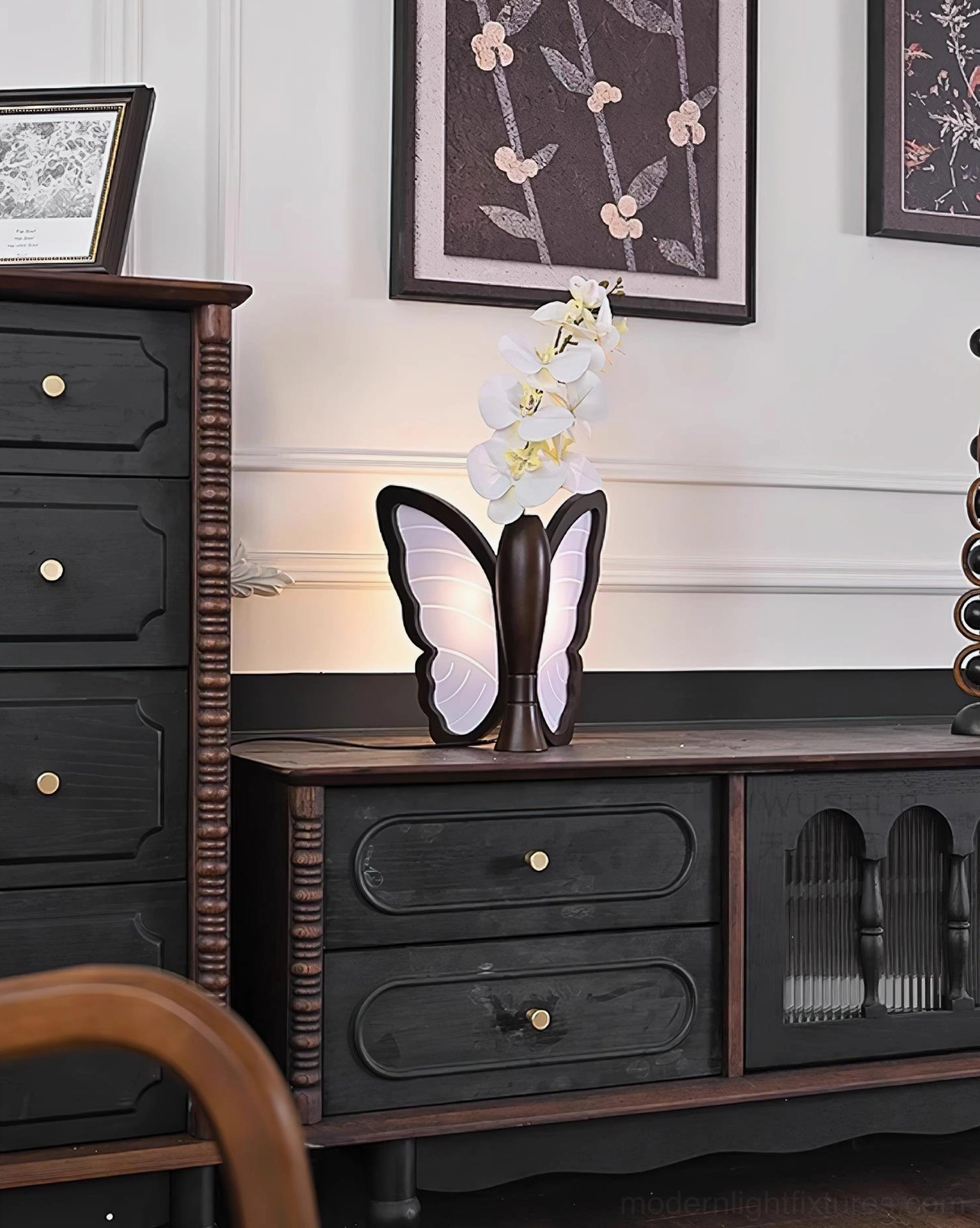 Butterfly table lamp positioned on living room console table with matching dark wood furniture and wall decor