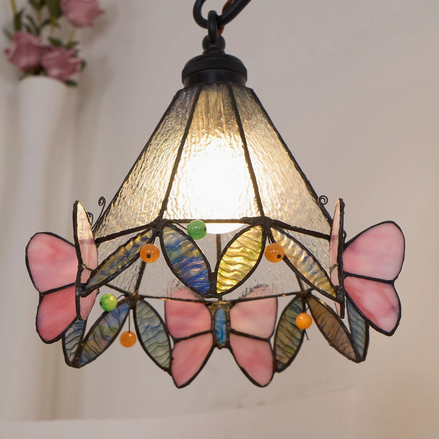 Butterfly stained glass table lamp in reading corner creating comfortable task lighting