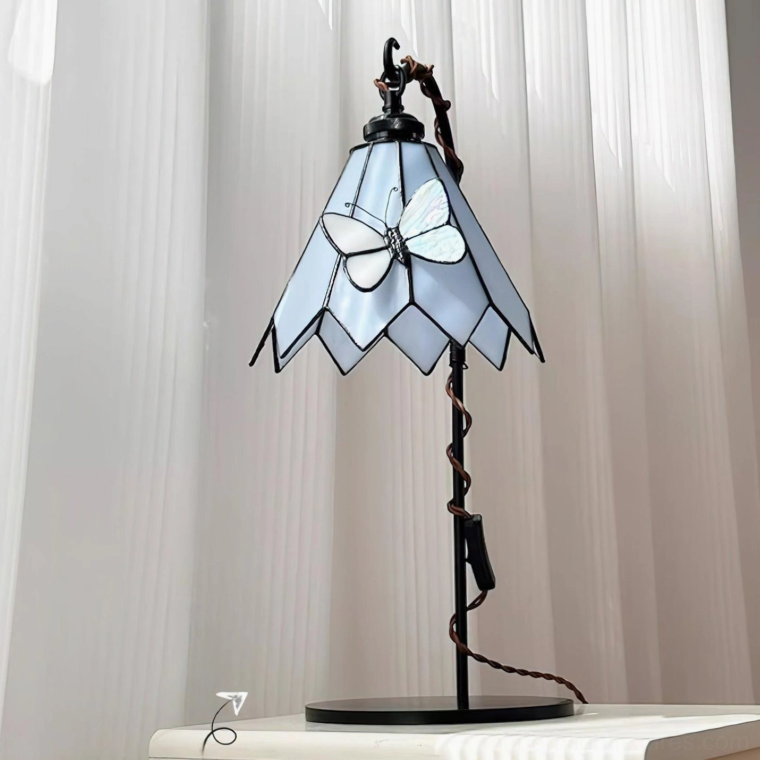 Stained glass butterfly table lamp with vine-inspired stand detailed side profile view