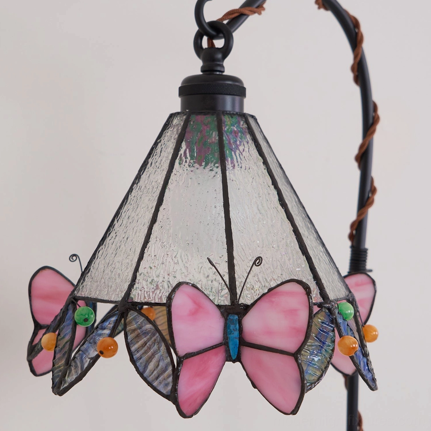 Stained glass butterfly table lamp with vine-inspired black stand architectural view