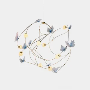Modern butterfly pendant chandelier with translucent blue butterfly ornaments on brass curved framework, featuring soft glowing acrylic sphere elements in warm white lighting