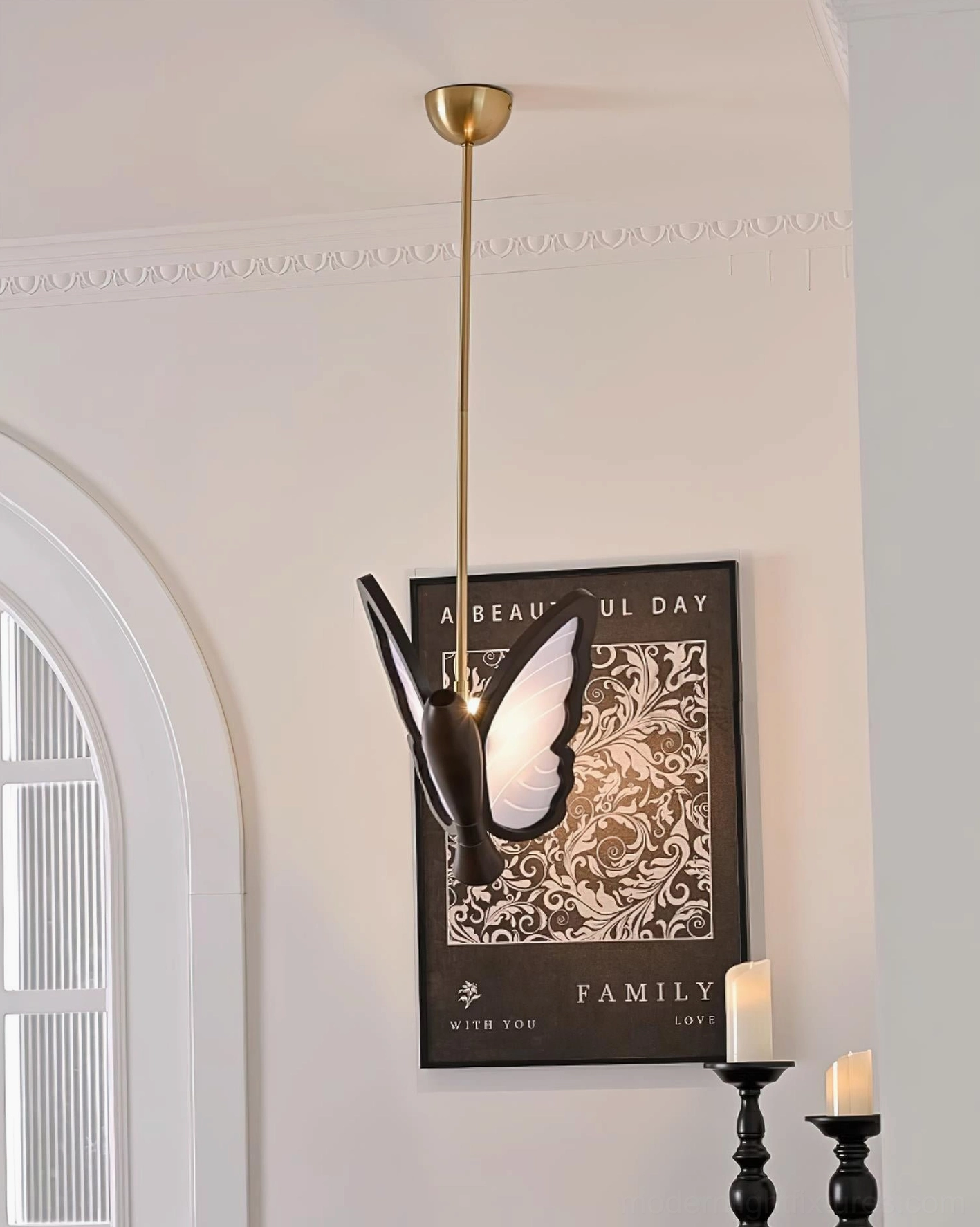 Butterfly pendant lamp viewed through arch window in European-style corridor with classic neutral home decor
