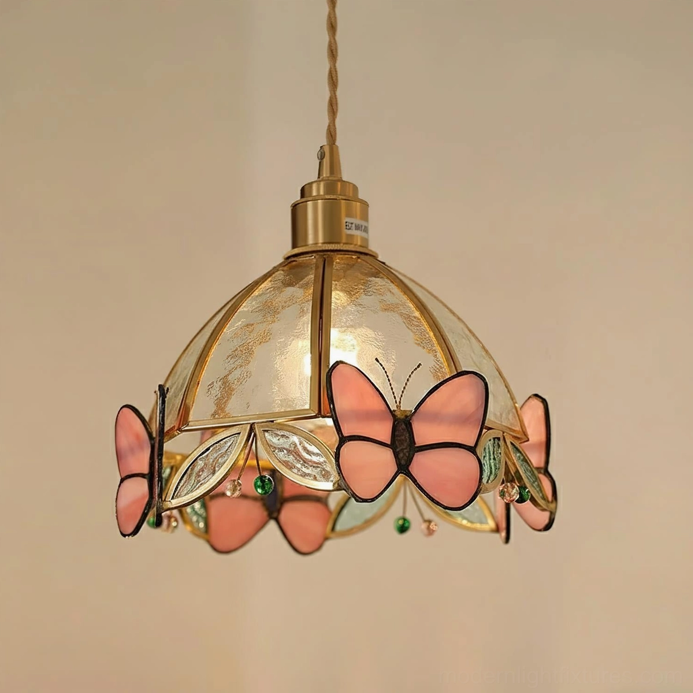 Pink butterfly stained glass pendant lamp showcasing gem-like quality with warm-toned brass accents