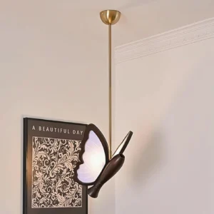 Modern butterfly pendant lamp in gold finish displayed in luxury home interior with vintage wall art and ornate decor