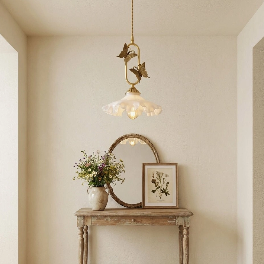 Brass butterfly pendant light above kitchen island, white jade shade providing task and ambient lighting