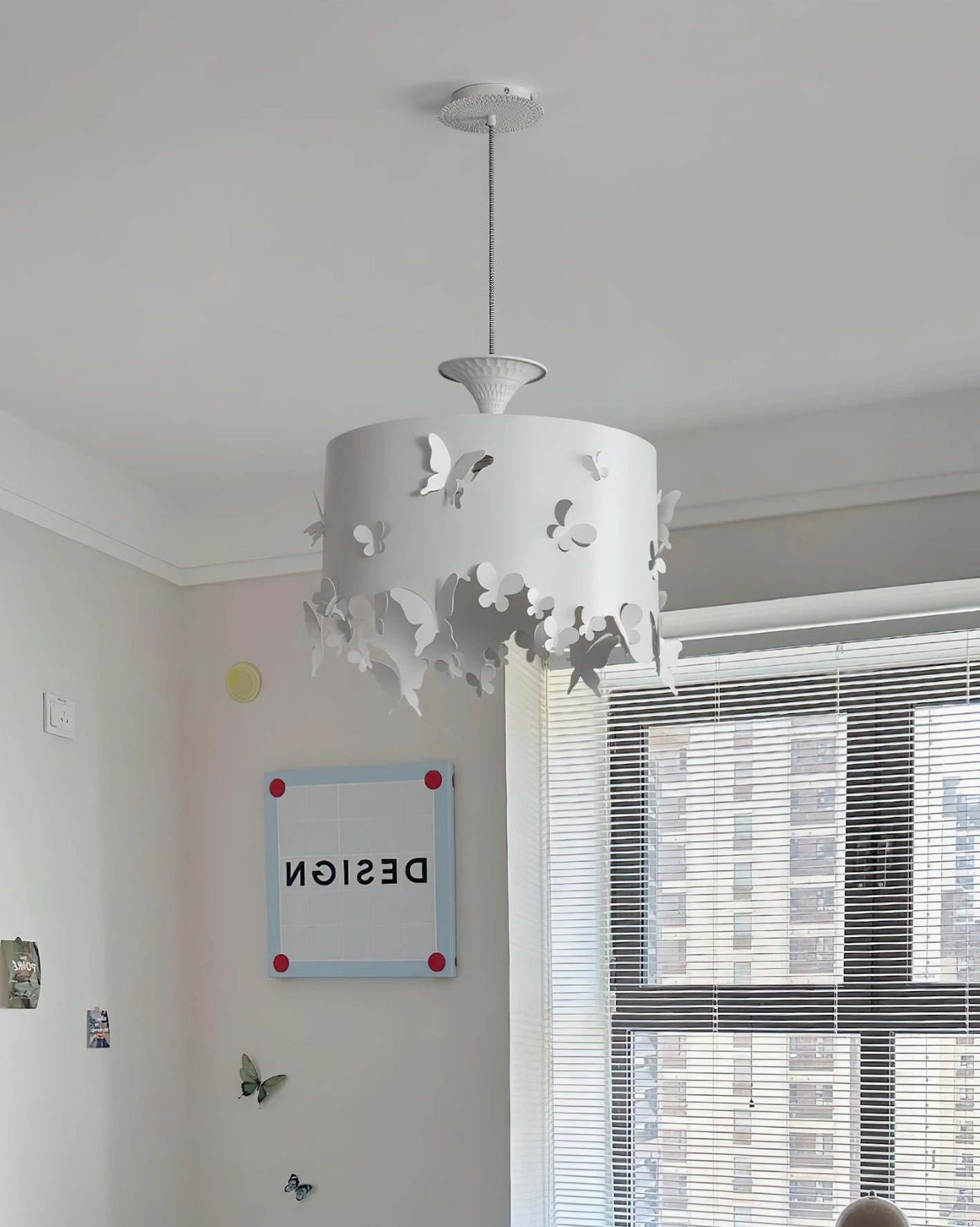 Sculptural butterfly pendant lamp in contemporary living room with neutral decor and window, creating soft whimsical illumination