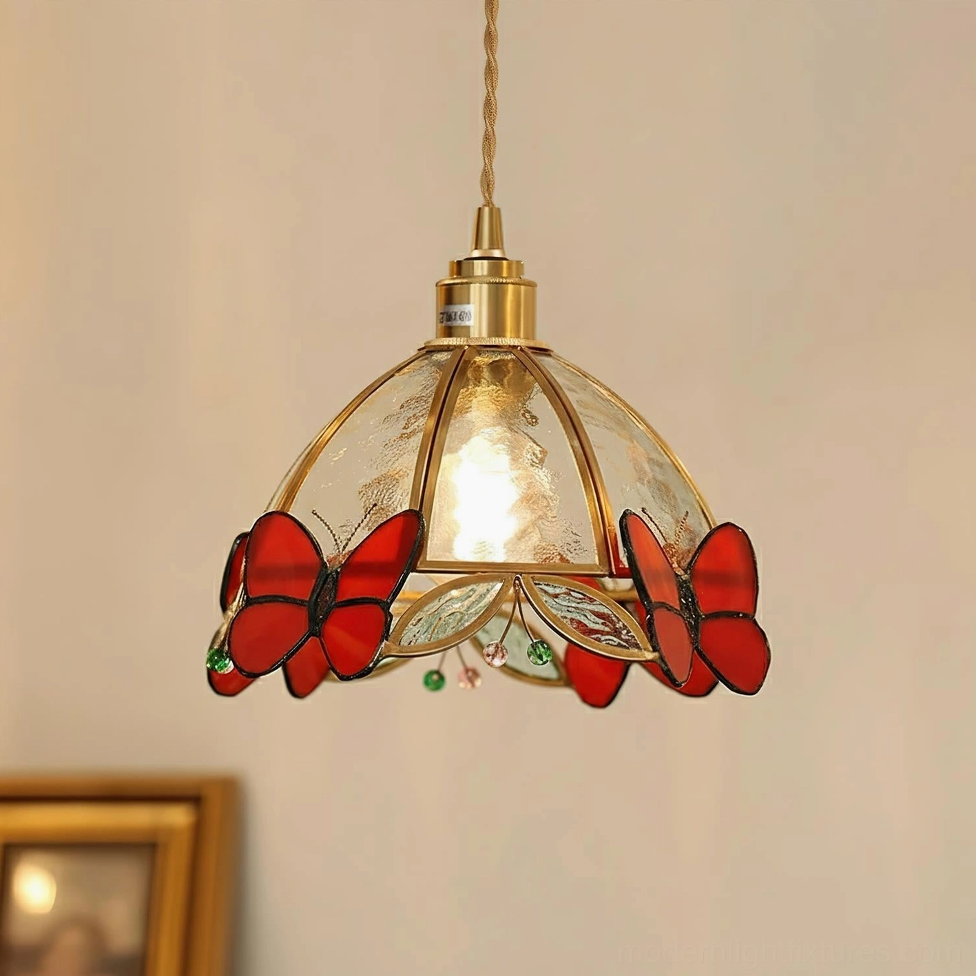 Red butterfly stained glass pendant lamp with brass hardware and frosted glass shade in close-up hanging view