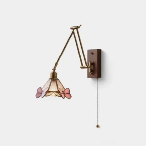 Butterfly swing arm wall sconce with stained glass shade in brass and walnut finish, front studio view