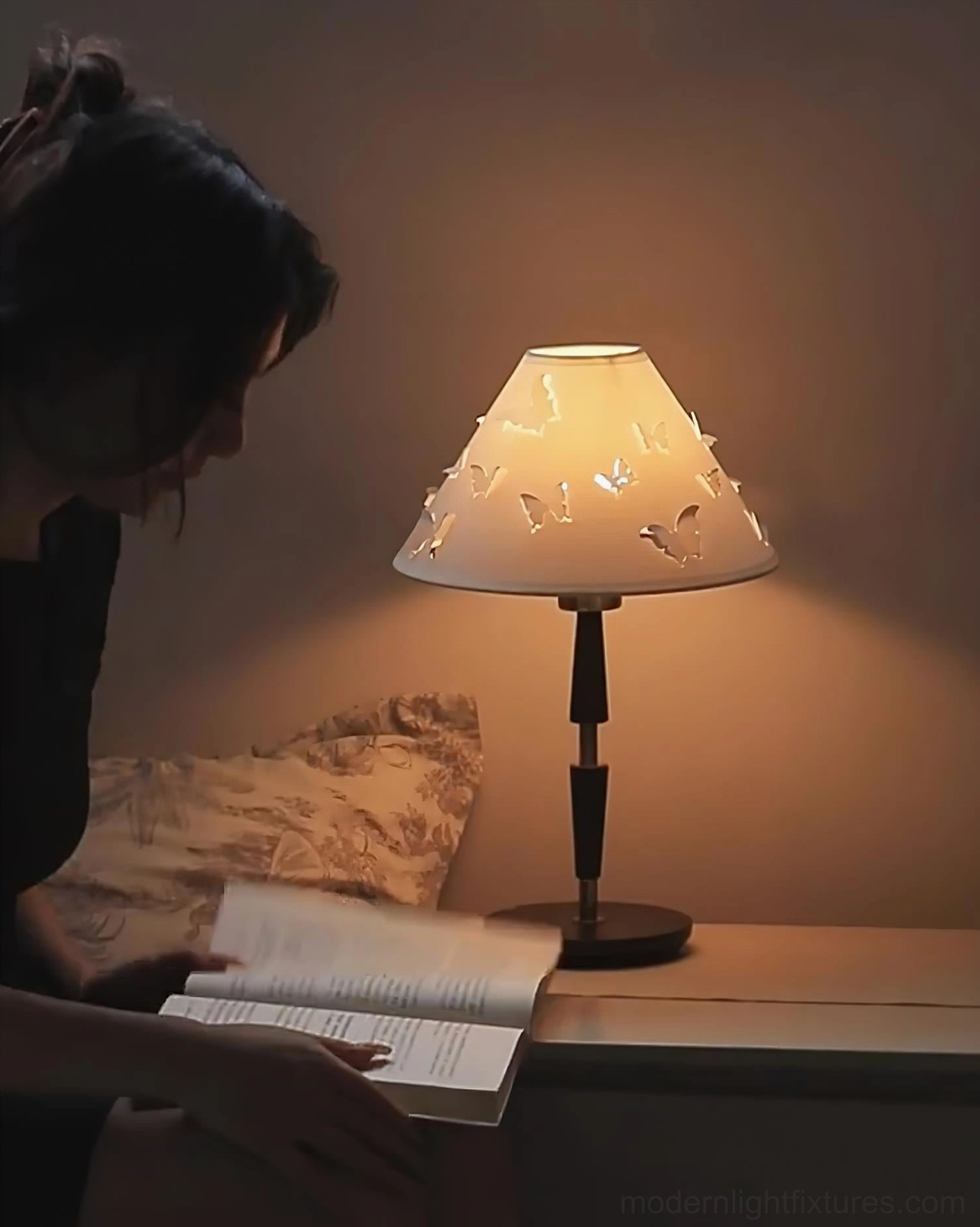 Butterfly table lamp on bedroom nightstand with soft warm lighting creating relaxing bedside ambiance
