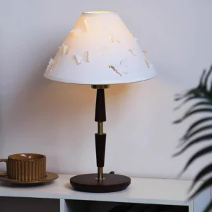 Butterfly table lamp displayed on side table with ceramic coffee cup in contemporary interior setting
