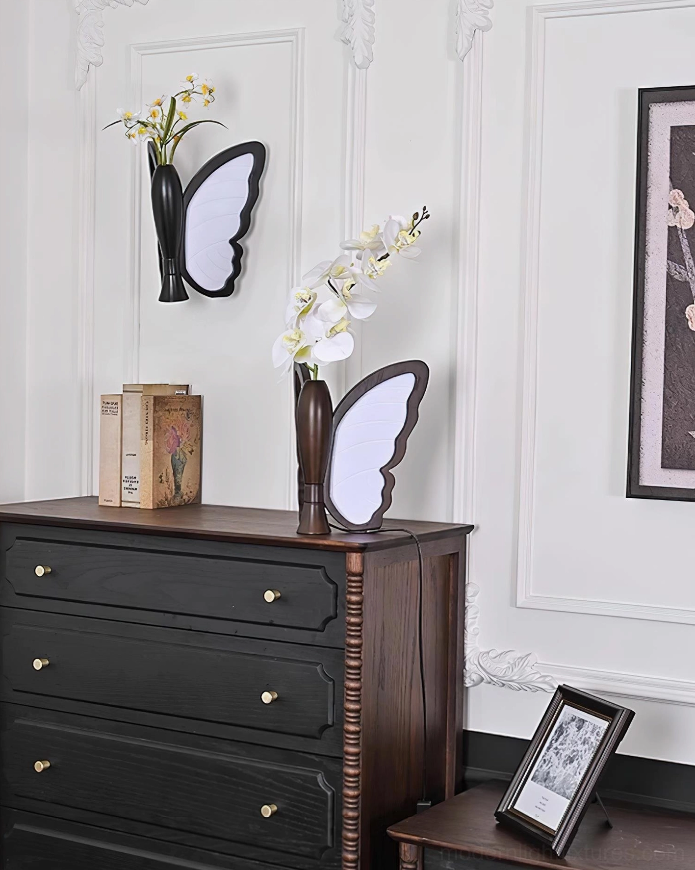 Two butterfly lamps on corner bedroom setup with framed photograph and retro home décor styling