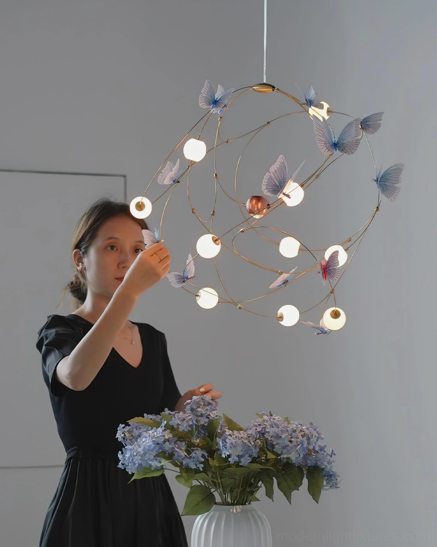 Butterfly-themed pendant chandelier showcasing delicate brass wire framework and translucent butterfly ornament details in modern design