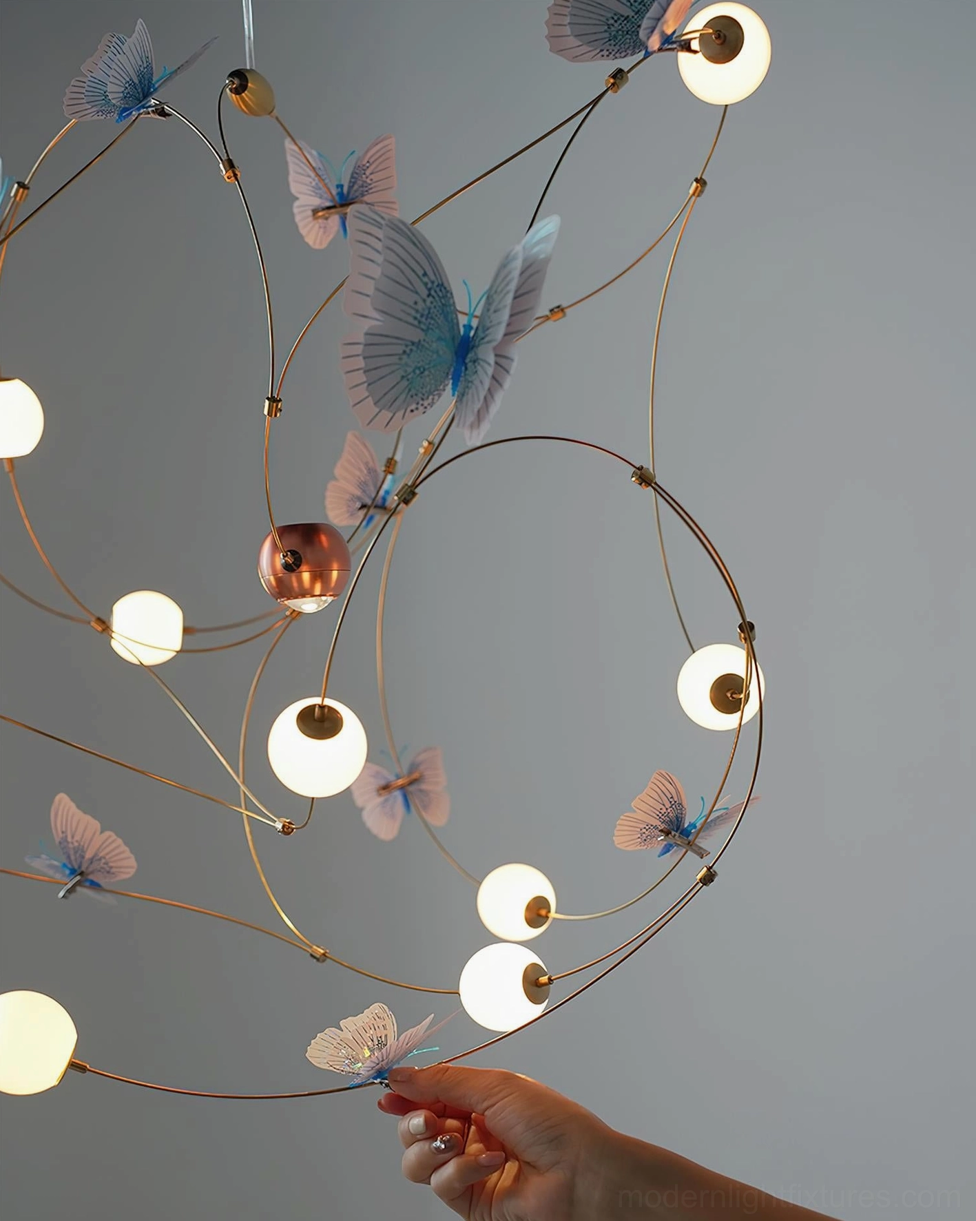 Contemporary butterfly-themed pendant lighting with integrated warm white LED and artistic brass framework design