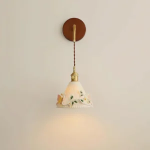 Off-white butterfly wall lamp mounted on residential wall with warm glowing light and twisted fabric cord
