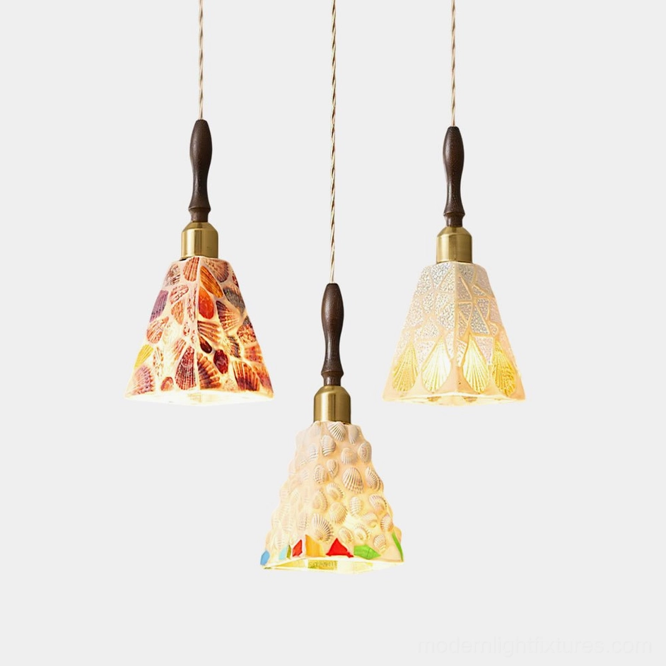 Cabana coastal pendant lights overhead view showing three handcrafted seashell glass shades with wood and brass fixtures