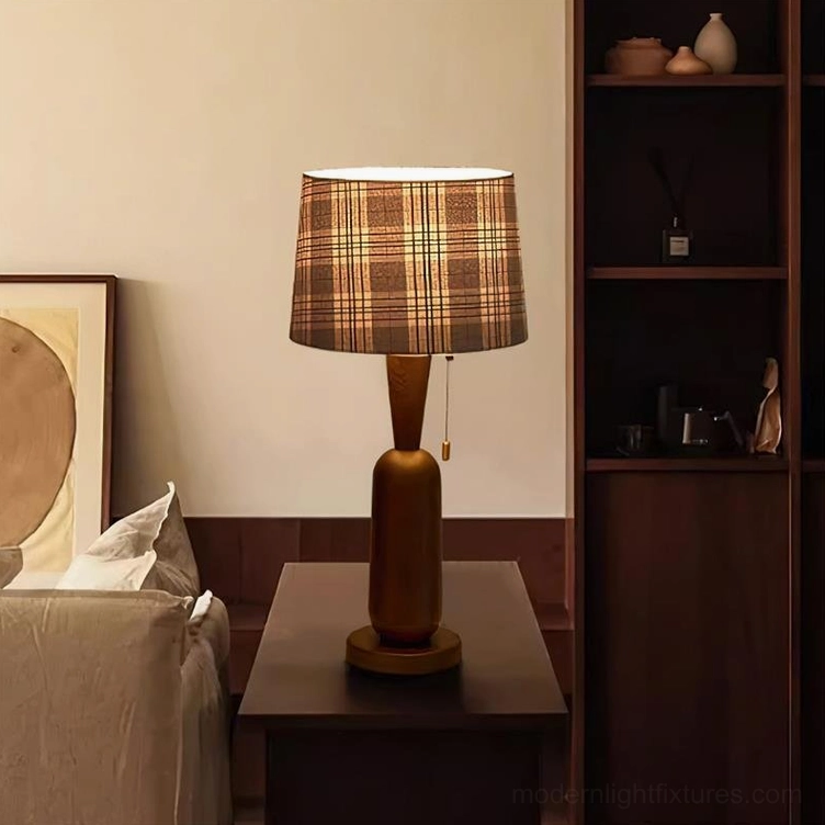 Rustic cabin table lamp with plaid shade on dark wood furniture in living room