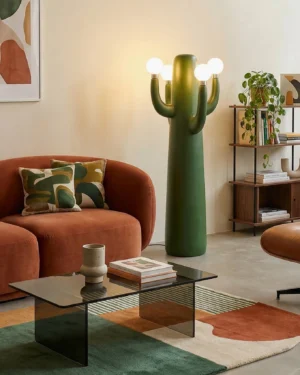 Dark green cactus sculptural floor lamp with illuminated frosted bulbs in mid-century modern living room setting
