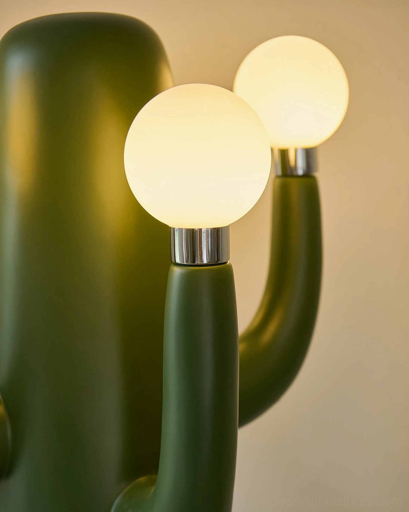 Close-up detail of cactus floor lamp arm with metallic base, frosted white bulbs and branching design